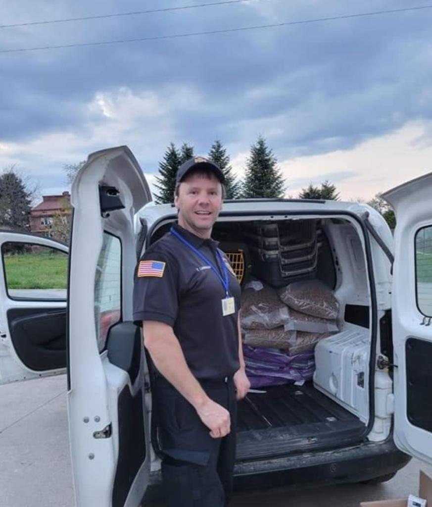 Founder standing at van with supplies